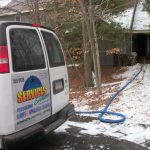 Carpet cleaning truck mount with hoses run into home